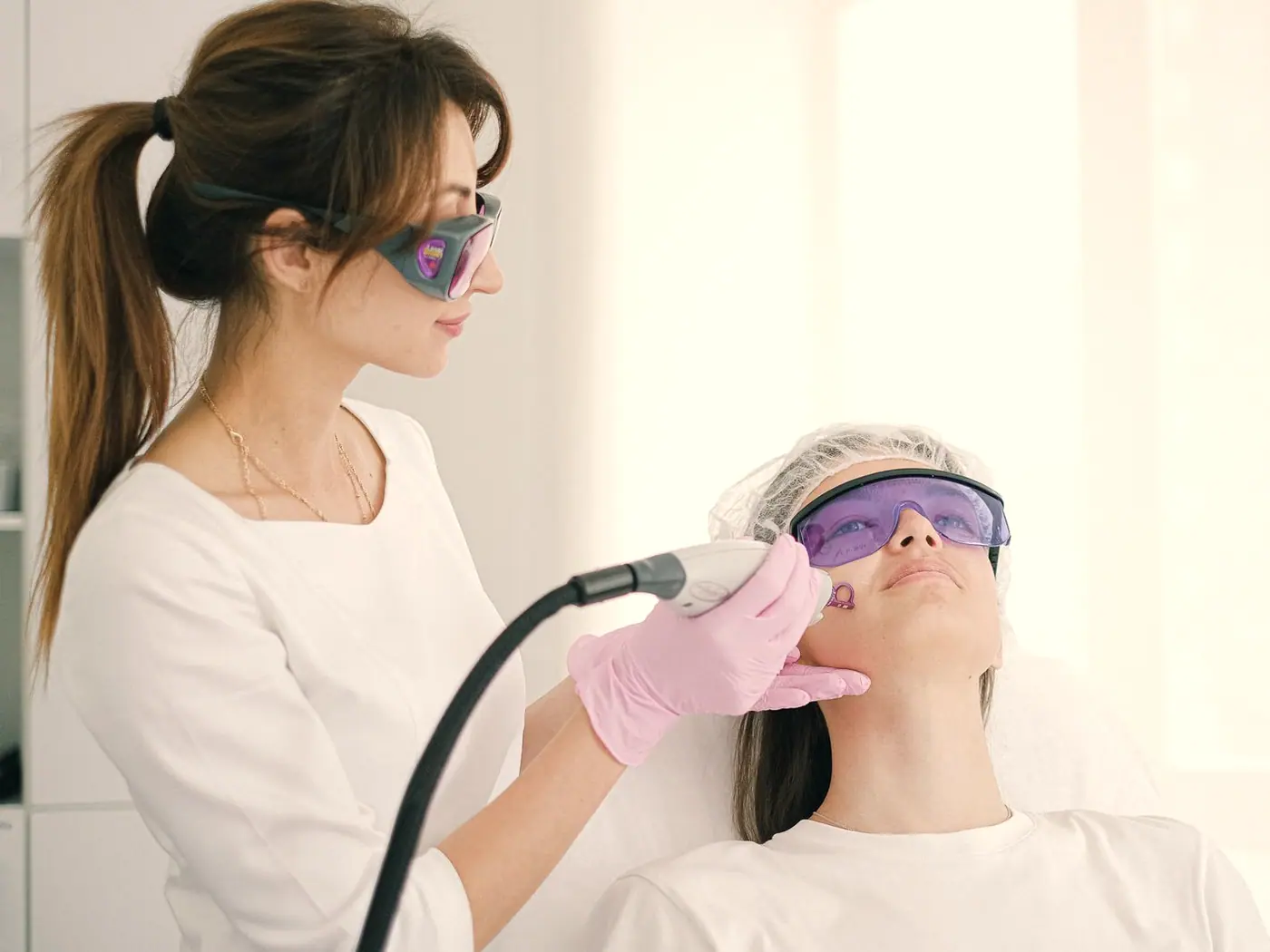 A laser skin treatment being carried out under clinic lighting